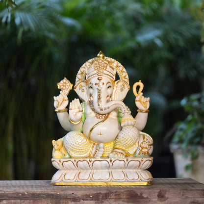 23" Chaturbuja Ganesha in Marble, this fine carving of Ganapati is sitting on a lotus base, its painted in light colours to add depth to the artifcat.