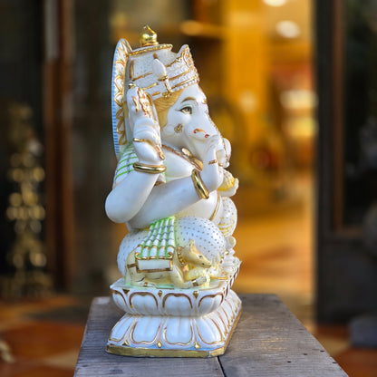 23" Chaturbuja Ganesha in Marble, this fine carving of Ganapati is sitting on a lotus base, its painted in light colours to add depth to the artifcat.