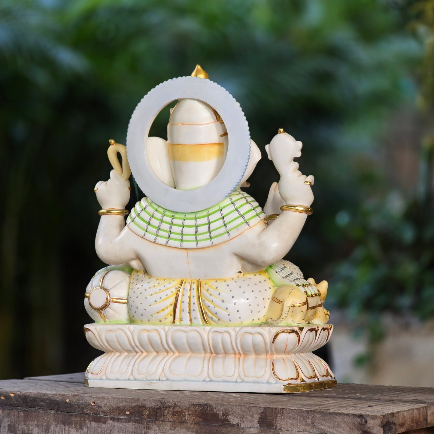 23" Chaturbuja Ganesha in Marble, this fine carving of Ganapati is sitting on a lotus base, its painted in light colours to add depth to the artifcat.